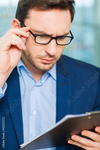 Businessman checking the report.