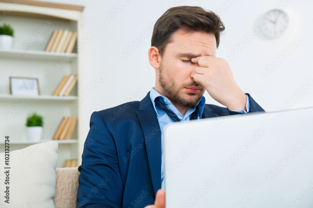Handsome young man looks overwhelmed with work Handsome young man looks overwhelmed with work
