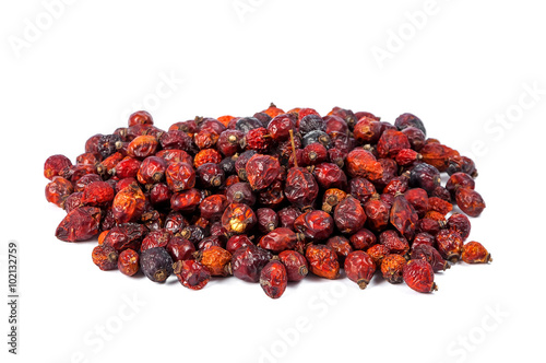 Pile of dried rose hips isolated on white background