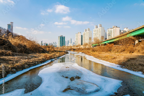 Photography icy river with buildings