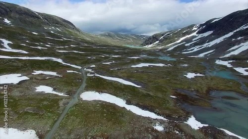 Aerial view of cars driving through scenic mountain pass Gamle Strynefjellsvegen in Norway. Aerial 4k Ultra HD. photo