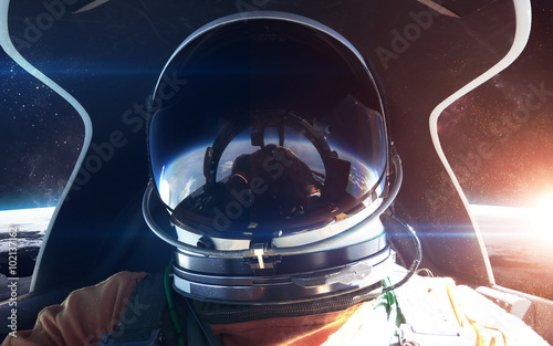 Fototapeta Naklejka Na Ścianę i Meble -  Brave astronaut in the spaceship cabin. This image elements furnished by NASA