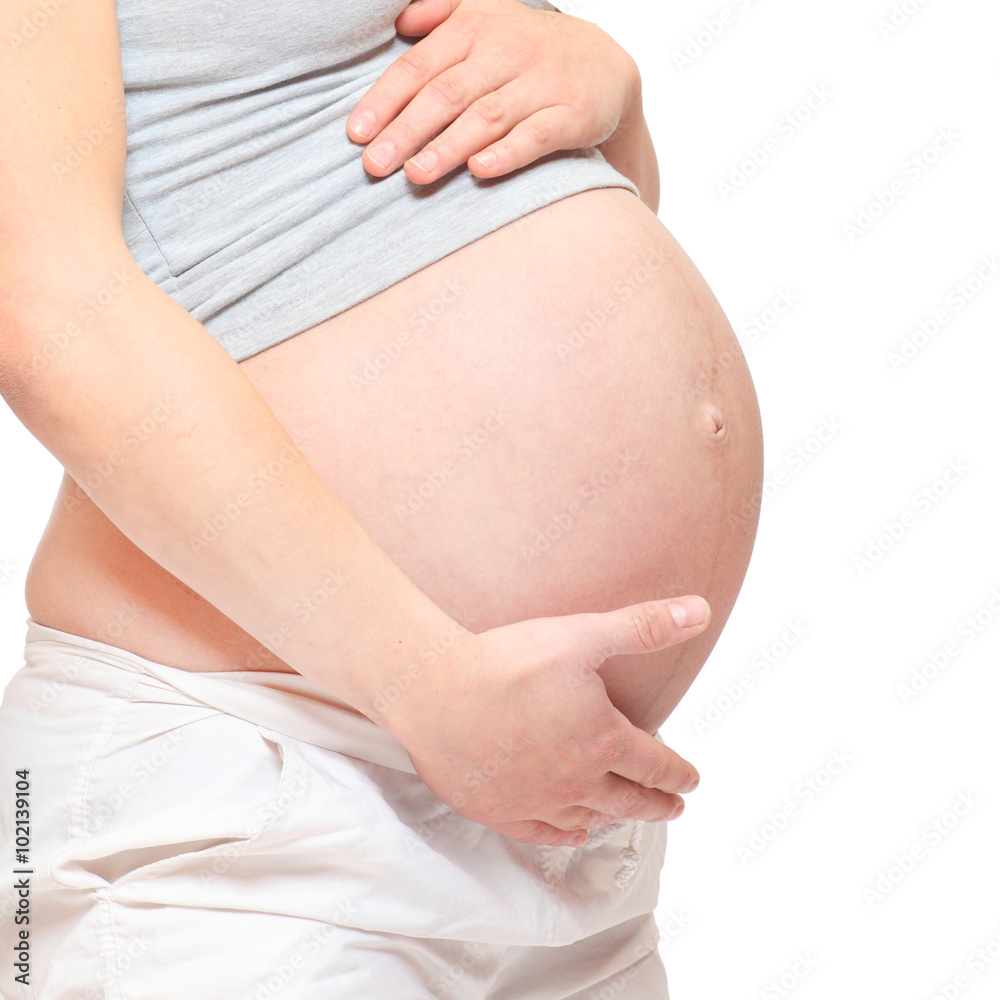 Pregnant belly on white background. Pregnancy and maternity concept. Pregnant belly on white background. Pregnancy and maternity concept.