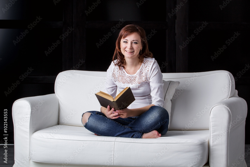 girl sitting on a white sofa girl sitting on a white sofa
