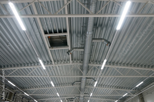 Industrial steel ventilation pipes inside of building.