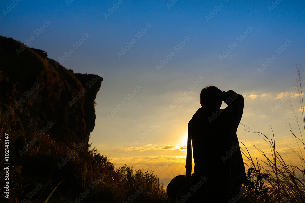 Silhouette of a photographer at sunrise