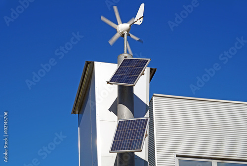 Solar panel with domestic wind turbine