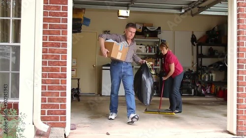  Mature couple working to clean the garage.