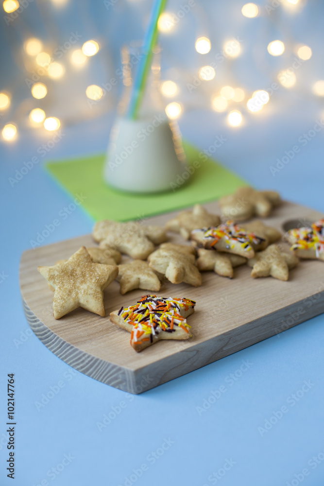Sweet Christmas cookies with milk on wooden desks