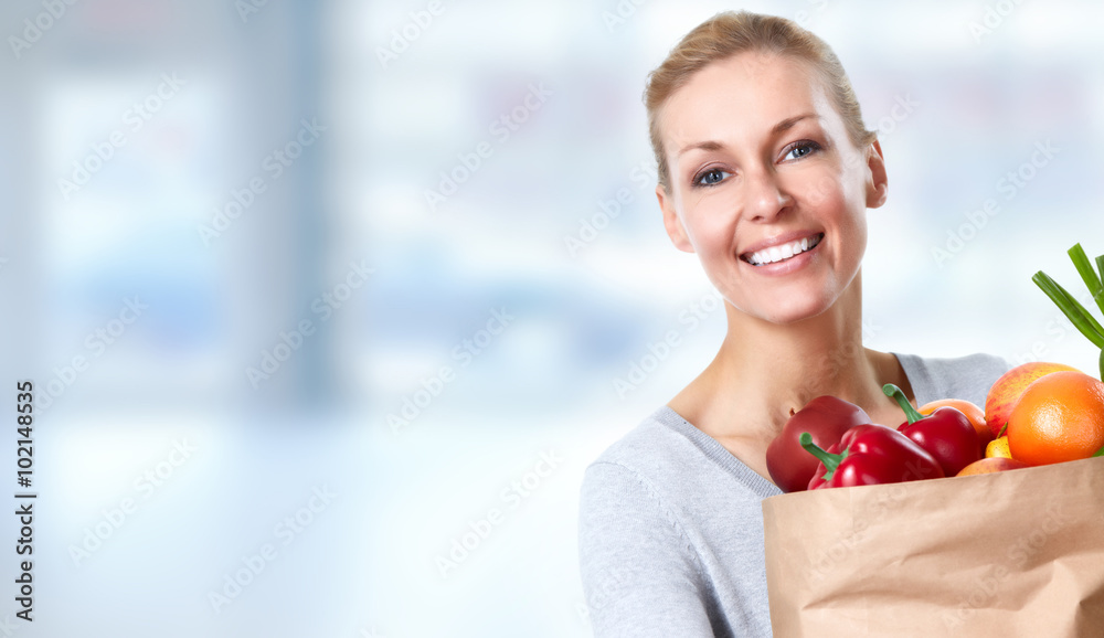 Beautiful woman holding shopping bag with food. Beautiful woman holding shopping bag with food.