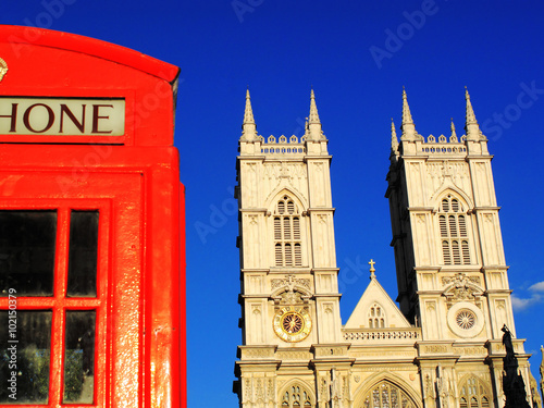 Traditional red London phone box and Westminster Abbey, England, UK