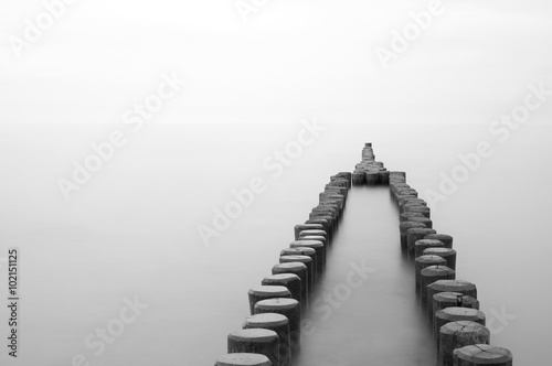 old wooden breakwater at the beach, black and white, long time exposure, German Baltic Sea Coast, Europe