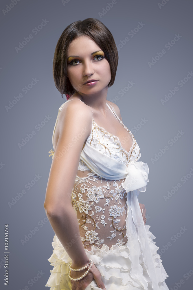 Wedding Dress Concept. Sexy Looking Caucasian Female Posing in Wedding Dress Wedding Dress Concept. Sexy Looking Caucasian Female Posing in Wedding Dress