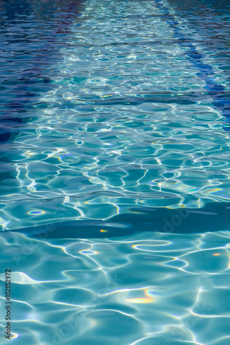 Background of rippled pattern of clean water in a blue swimming pool