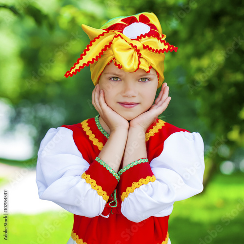 Little girl is dressed in the Russian national dress in summer p photo