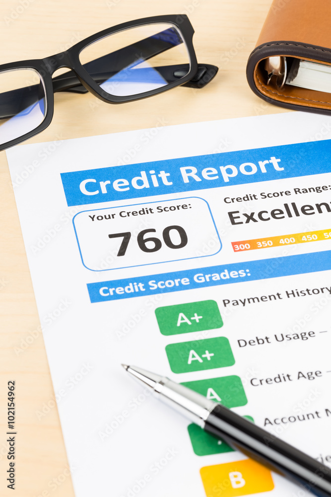Credit score report with pen, glasses, and organizer book Credit score report with pen, glasses, and organizer book