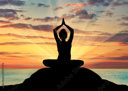 Slika na platnu Silhouette of a girl practicing yoga