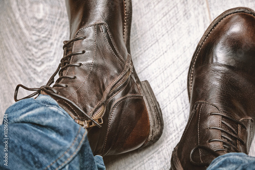 boots and jeans on men's feet close up © Yuli