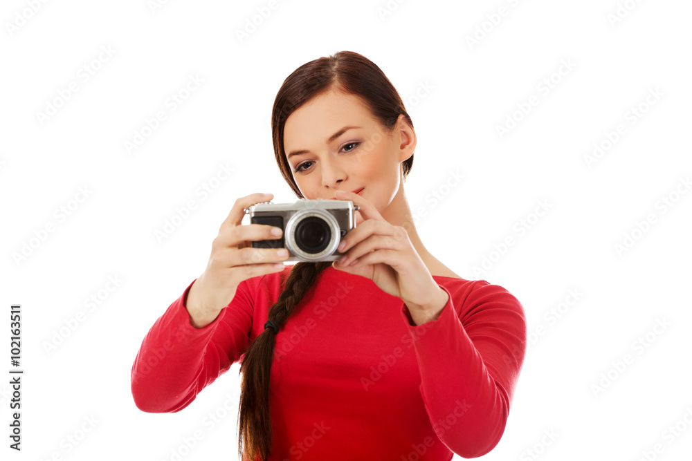 Pretty woman taking a photo using classic slr camera Pretty woman taking a photo using classic slr camera