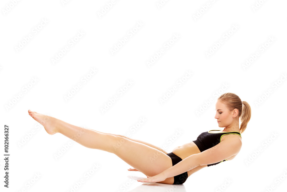 Young woman doing exercise on the floor Young woman doing exercise on the floor