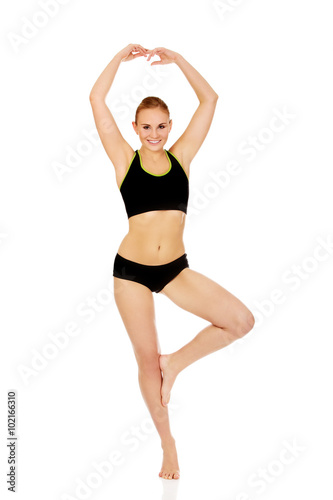 Yuong athletic woman doing balet pose