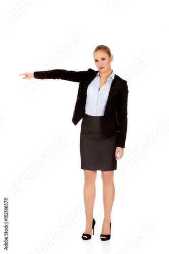 Angry business woman shows get out gesture