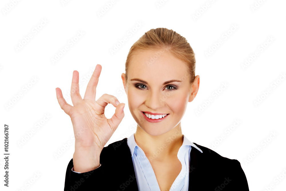 Young happy business woman shows OK sign Young happy business woman shows OK sign