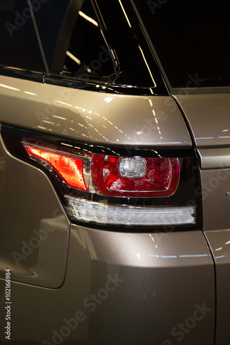 Closeup of a new brown car red brakes lights