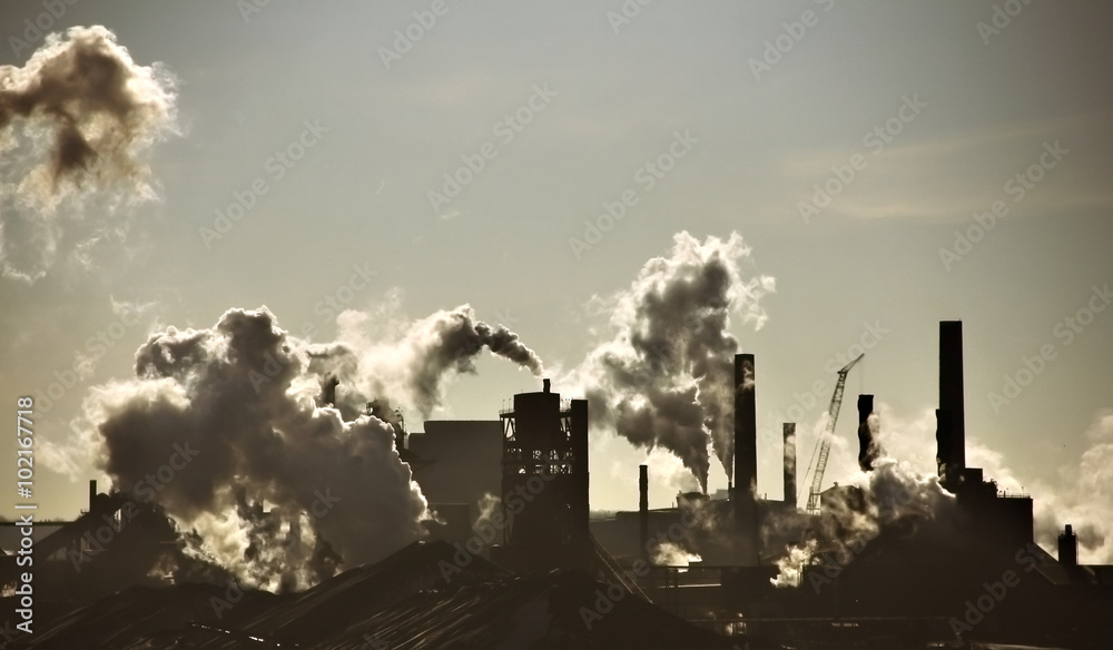 Steel-mill plant scenery line with fuming chimney-stalks in Hamilton Ontario