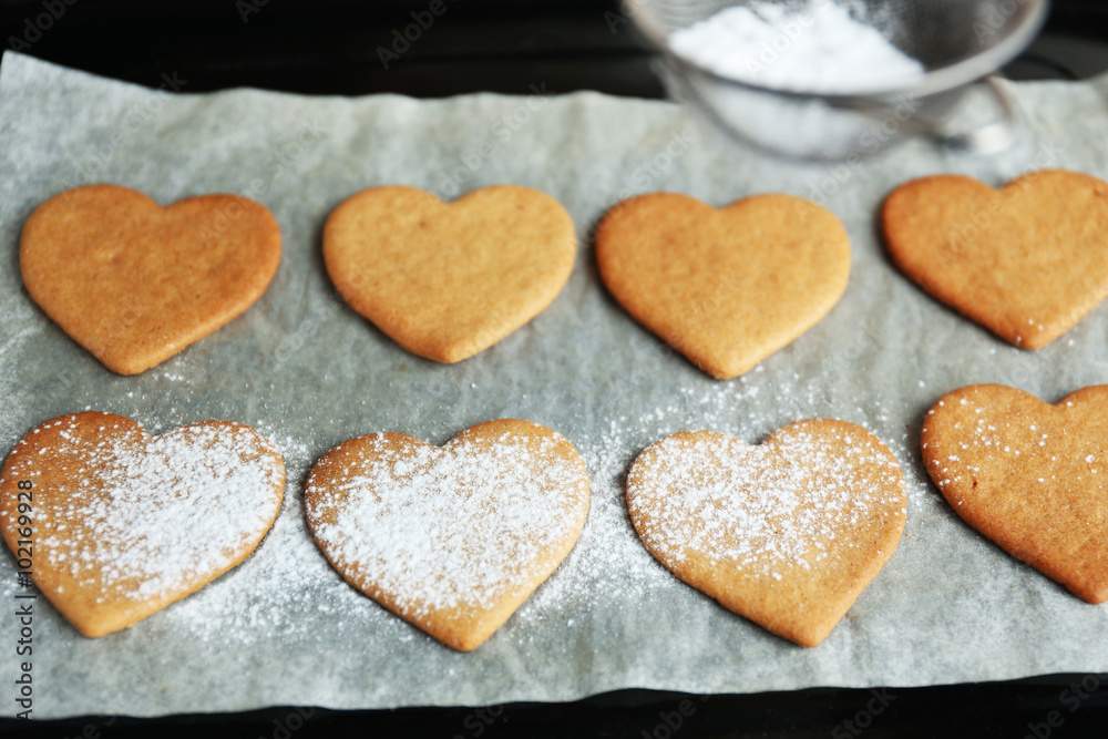 Process of powdering heart shaped cookies Process of powdering heart shaped cookies