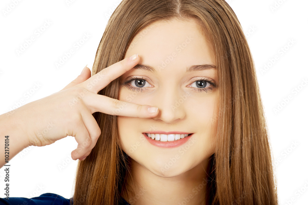 Happy teenager with victory sign on eye. Happy teenager with victory sign on eye.