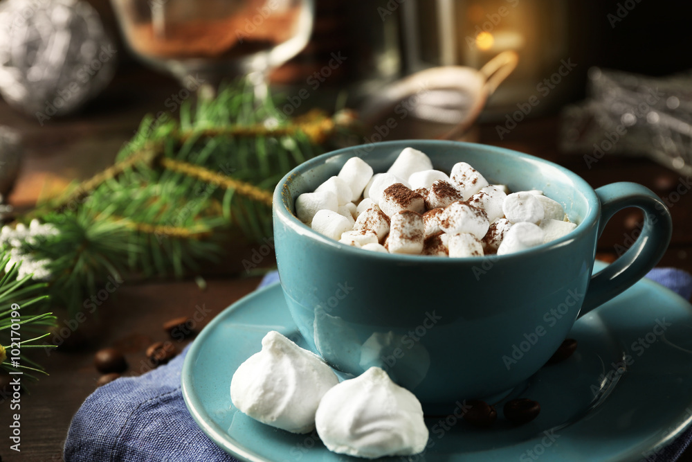 Mug of hot chocolate with marshmallows, fir tree branch on wooden background Mug of hot chocolate with marshmallows, fir tree branch on wooden background