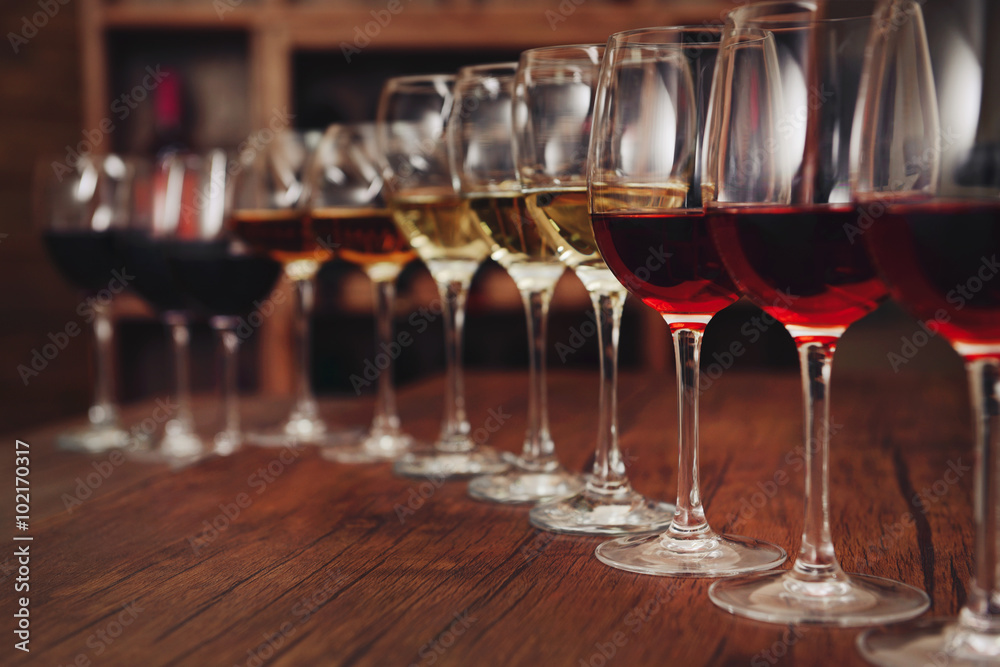 Many glasses of different wine in a row on bar counter Many glasses of different wine in a row on bar counter