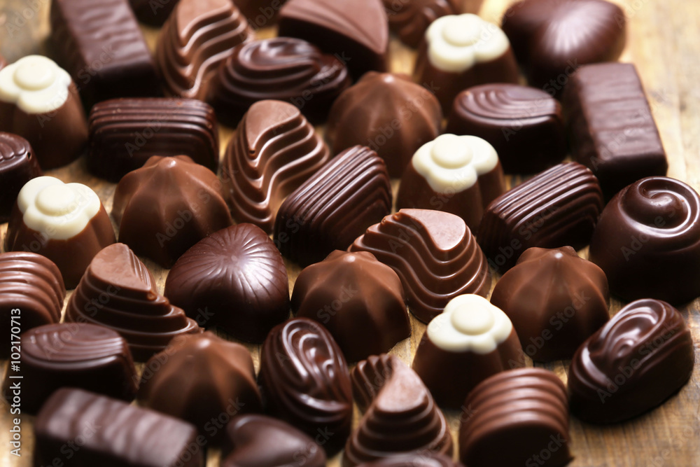 Assortment of delicious chocolate candies background, close up Assortment of delicious chocolate candies background, close up