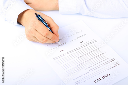 Businessman is signing a contract, business contract details