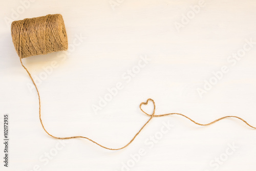 Heart made from string on white background