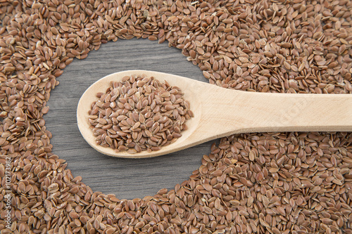 Flax seeds close up on a wooden spoon on a table. horizontal