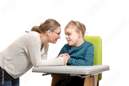 Disability a special needs child in a wheelchair / Disability a disabled child in a wheelchair relaxing together with a carer
