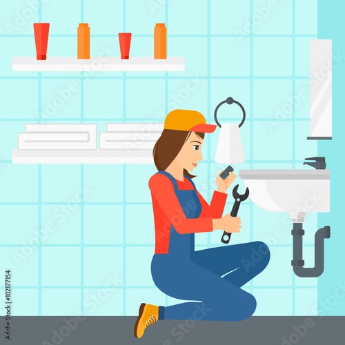 Woman repairing sink.