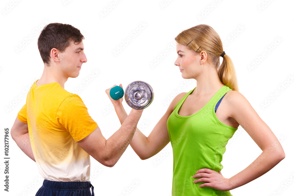 Couple exercising with dumbbells lifting weights Couple exercising with dumbbells lifting weights