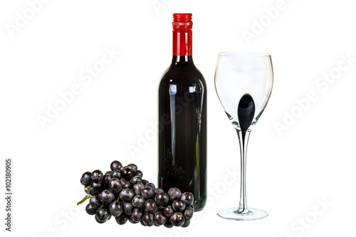 Red wine with glass and red grapes on white background