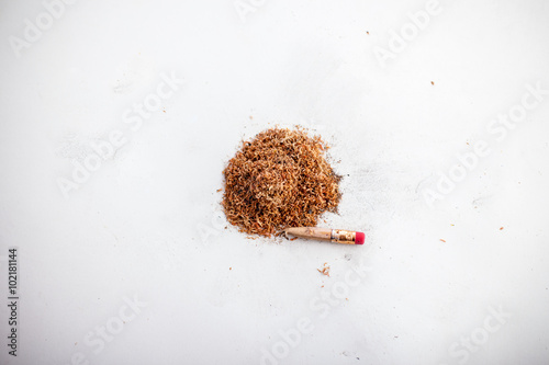 Broken Pencil and Shavings on Dirty White Paper