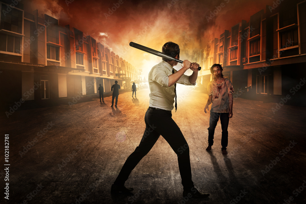 Man in white shirt holding baseball bat