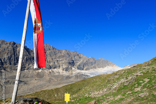 Mountain panorama with Austrian flag in Hohe Tauern Alps, Austria