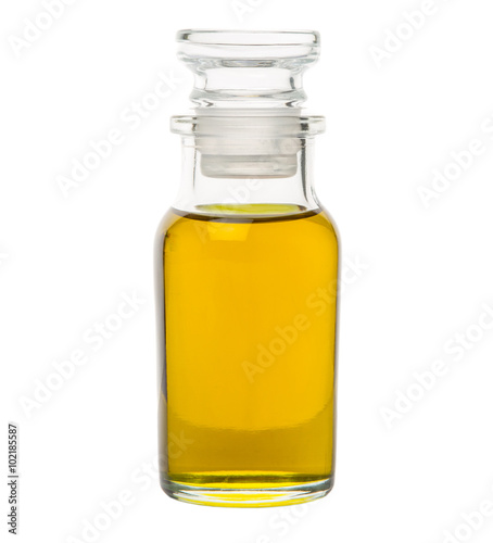 Avocado fruit oil extract in glass vial over white background