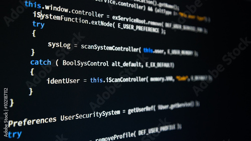 Software developer programming code. Abstract computer script code. Shallow depth of field, selective focus effect.