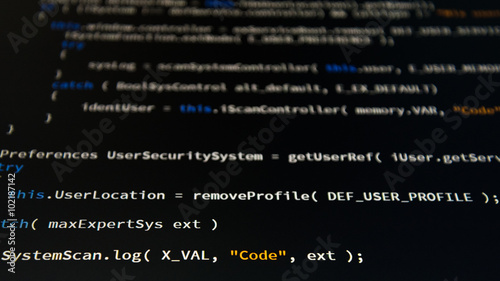 Software developer programming code. Abstract computer script code. Shallow depth of field, selective focus effect.