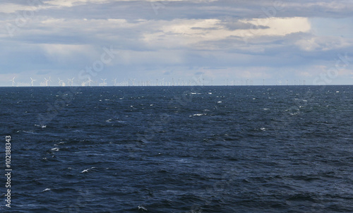 Windmills on the horizont surrounding by sea