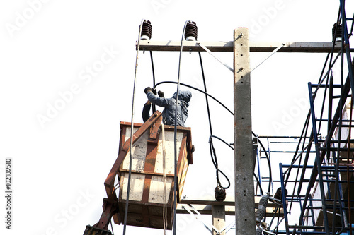 Electrician working on electric power pole by mobile crane