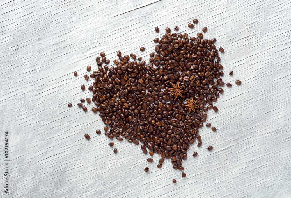 Heart shape made from coffee beans on wooden background Heart shape made from coffee beans on wooden background